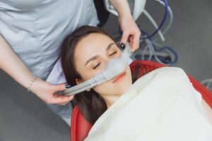 A woman undergoing sedation dentistry in Melville, NY